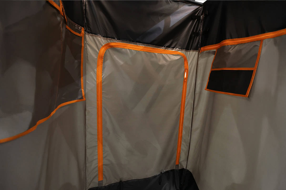 Interior view of Kimberley Kampers Kube teardrop camper with Darche shower setup, highlighting a compact and functional camping space.