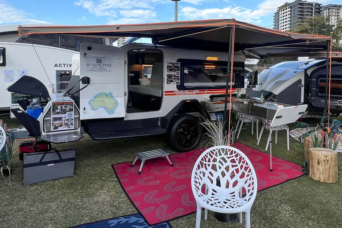 Kimberley Kampers Kube teardrop camper with Darche awning set up in a scenic outdoor environment.