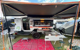 Kimberley Kampers Kube teardrop camper with Darche awning extended, showcasing a compact outdoor setup.