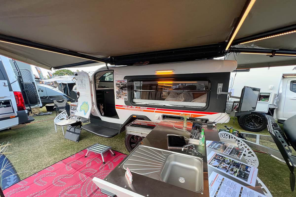 Kimberley Kampers Teardrop Kube Camper with Darche awning fully extended, showcasing a compact outdoor camping setup.