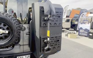 : Australian offroad motorhome storage box mounted on a rugged vehicle, featuring a durable design with a shovel attached for outdoor adventures.