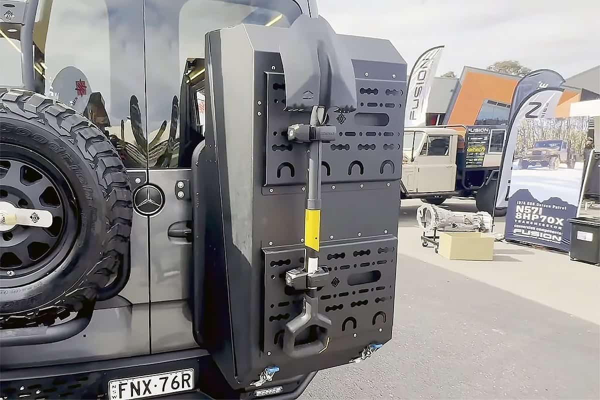 : Australian offroad motorhome storage box mounted on a rugged vehicle, featuring a durable design with a shovel attached for outdoor adventures.